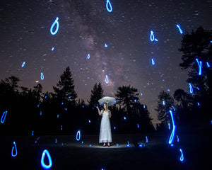 A woman surrounded by glowing light painting forms in this stop-motion short film by Dariustwin.